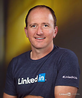Chad Chelius smiles wearing his LinkedIn Learning shirt