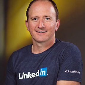 Chad Chelius smiles wearing his LinkedIn Learning shirt
